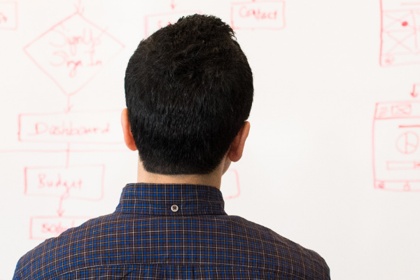 man in front of whiteboard