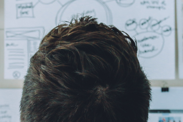 Person in front of board of drawings